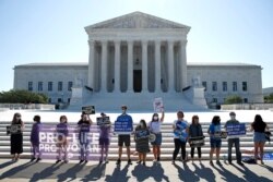 Anti-abortion protesters wait outside the Supreme Court for a decision, June 29, 2020. in Washington.