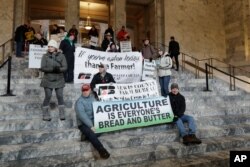 Farmers and other supporters hold signs Jan. 13, 2020, at the Capitol in Olympia, Wash., during a day to raise awareness of issues facing farmers in Washington state on the first day of the 2020 session of the Washington legislature.