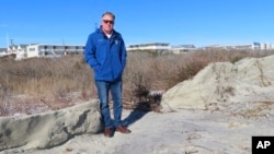 Mayor Patrick Rosenello stands next to a destroyed section of sand dune in North Wildwood, New Jersey, on Jan. 22, 2024. A winter storm punched a hole through what is left of the city's eroded dune system, leaving it more vulnerable than ever to flooding.