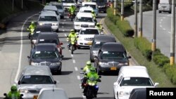 Hearses carry coffins with the remains of Brazilians victims who died in a plane crash that crashed in the Colombian jungle with the Brazilian soccer team Chapecoense in Medellin, Colombia, Dec. 2, 2016. 