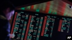FILE - Odds are displayed on a screen at a sports book owned and operated by CG Technology in Las Vegas, Jan. 14, 2015.