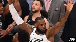 Reaksi LeBron James (depand) dan Stephen Curry (belakang) saat tim LeBron mengalahkan tim Stephen 148-145 dalam laga NBA All-Star di Staples Center di Los Angeles, California, 18 Februari 2018. (Foto: Robyn Beck/AFP).