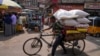 FILE - A rickshaw puller transports a load at a wholesale market in Hyderabad, India, Thursday, Feb. 1, 2024. India's policymakers are trying to head off a sharp slowdown as global economic conditions worsen.