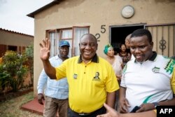 FILE — ANC president and South African President Cyril Ramaphosa (C) greets residents during a door-to-door campaign in Ekurhuleni on March 10, 2024 ahead of the South African presidential elections scheduled for May 29, 2024.