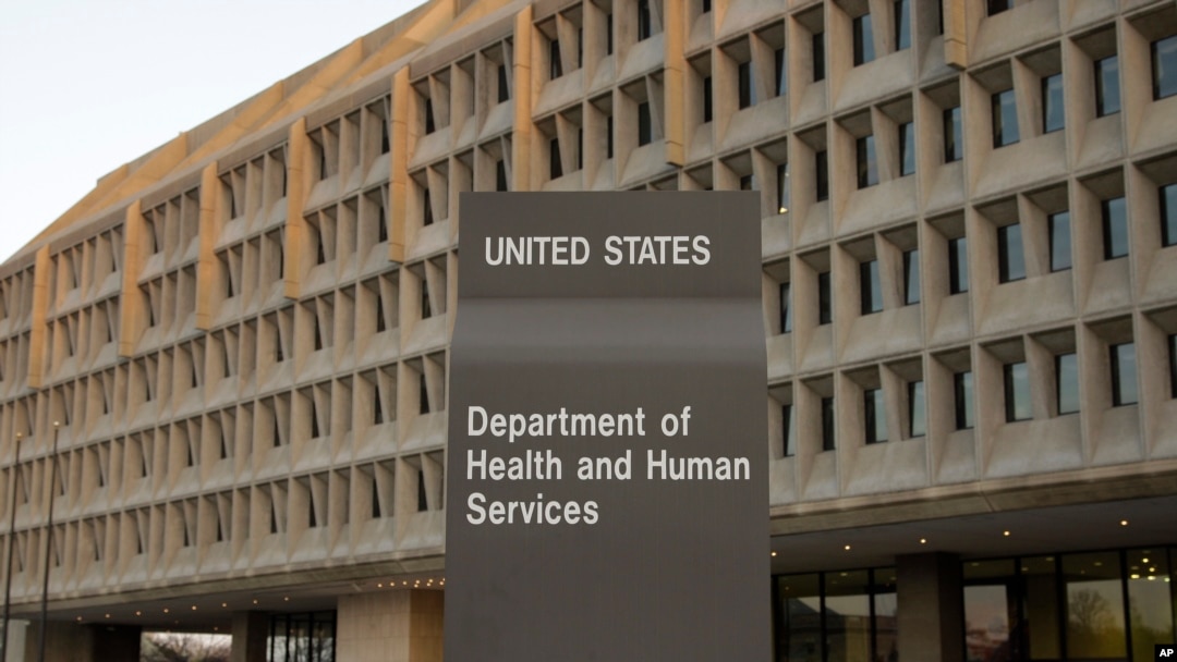 FILE - The Department of Health and Human Services building is seen in the evening in Washington.