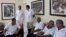 FILE - These Cuban doctors, waiting for the start of a press conference in Havana, were among 91 health workers who traveled to Liberia and Guinea to help with treatment of Ebola patients, Oct. 21, 2014.
