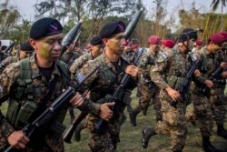 FILE - El Salvador army special forces march during a presentation to the press as part of a stepped-up phase in the government's fight against gangs in San Salvador, El Salvador, April, 20, 2016.
