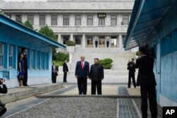 FILE - President Donald Trump meets with North Korean leader Kim Jong Un at the border village of Panmunjom in the Demilitarized Zone, South Korea, June 30, 2019.