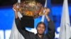 Coco Gauff of the United States celebrates with the championship trophy after defeating Karolina Muchova of Czech Republic in the women's singles final match at the China Open tennis tournament at the National Tennis Center in Beijing, Oct. 6, 2024. 