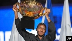 Coco Gauff of the United States celebrates with the championship trophy after defeating Karolina Muchova of Czech Republic in the women's singles final match at the China Open tennis tournament at the National Tennis Center in Beijing, Oct. 6, 2024. 