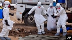 Nhân viên y tế thu nhặt xác một nạn nhân chết vì ebola trên đường phố thủ đô Liberia. Tổ chức Y tế Thế giới cho biết có thêm 84 người thiệt mạng ở Tây Phi vì dịch Ebola, nâng tổng số tử vong của dịch này lên tới 1,229 người.