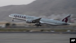 A Qatar Airways aircraft takes off with foreigners from the airport in Kabul, Afghanistan, Sept. 9, 2021, in the first such large-scale departure since U.S. and foreign forces concluded their frantic withdrawal from the country late last month.