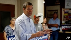 Kansas Secretary of State Kris Kobach and candidate for the Republican nomination for Kansas Governor addresses supporters during a campaign stop, Aug. 3, 2018, at the Fort Scott Livestock Market in Fort Scott, Kan. 