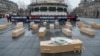 Members of Reporters Without Borders protest with 19 open caskets symbolizing the 19 Ukrainian journalists imprisoned in Russia and a closed one for Ukrainian journalist Victoria Roshchyna, who died in Russian detention, in Paris on Feb. 20, 2025.