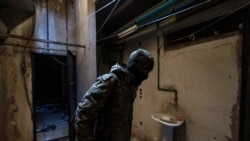 A rebel fighter inspects a room in the Syrian General Intelligence Directorate (GID) Branch 251, also known as Al-Khatib branch, in the capital Damascus on December 25, 2024.