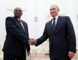 FILE - Russian President Vladimir Putin, right, shakes hands with Sudan's President Omar al-Bashir during their meeting in the Kremlin in Moscow, Russia, Saturday, July 14, 2018.