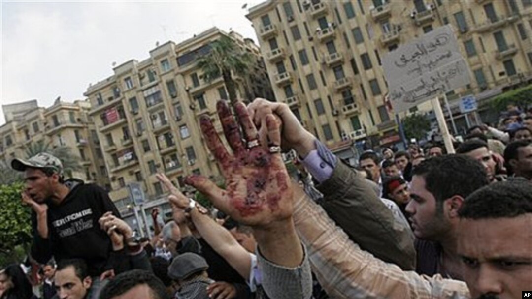 A protester holds up a bloodied hand following an attack by security forces in Tahrir Square, in Cairo, Egypt, April 9, 2011