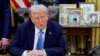 FILE - U.S. President Donald Trump looks on as he signs an executive order in the Oval Office at the White House in Washington, Jan. 31, 2025.