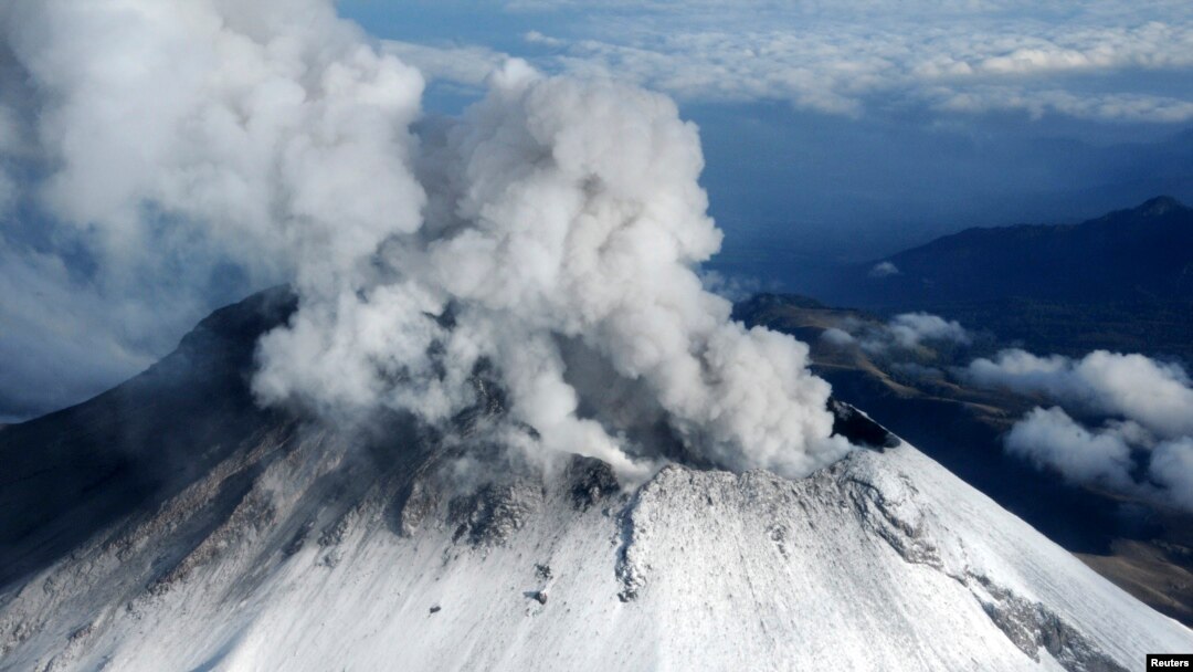 FILE - Popocatepetl volcano spews a cloud of ash and steam 2km (1.2 miles) into the air, in this aerial view taken on the outskirts of Puebla, July 10, 2013, in this handout provided by Mexico's Navy (SEMAR).