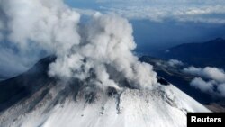 FILE - Popocatepetl volcano spews a cloud of ash and steam 2km (1.2 miles) into the air, in this aerial view taken on the outskirts of Puebla, July 10, 2013, in this handout provided by Mexico's Navy (SEMAR).