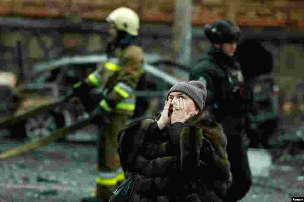 A woman reacts at the site of a Russian missile strike, amid Russia&#39;s attack on Ukraine, in central Kyiv, Ukraine.