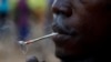 A young man smokes Kush at a hideout in Freetown, Sierra Leone, Monday, April 29, 2024. (AP Photo/ Misper Apawu)