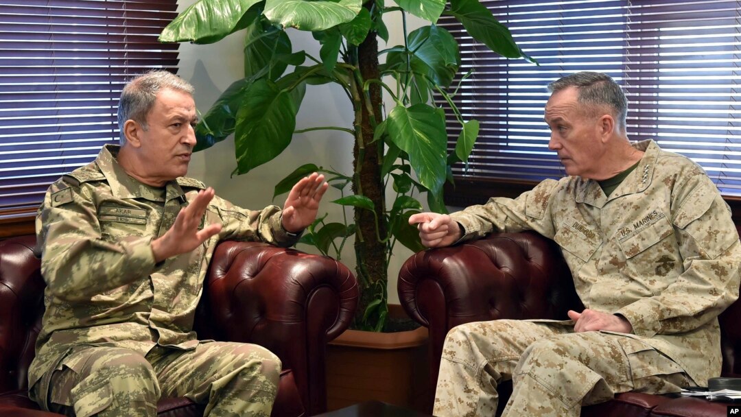 The U.S. chairman of the Joint Chiefs of Staff, Gen. Joseph Dunford, right, and Turkey's Chief of Staff Gen. Hulusi Akar talk during a meeting in Incirlik Airbase in Adana, Turkey, Feb. 17, 2017.