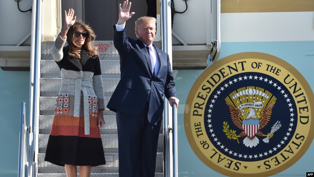 U.S. President Donald Trump and first lady Melania wave as they arrive at Yokota Air Base at Fussa in Tokyo, Nov. 5, 2017.