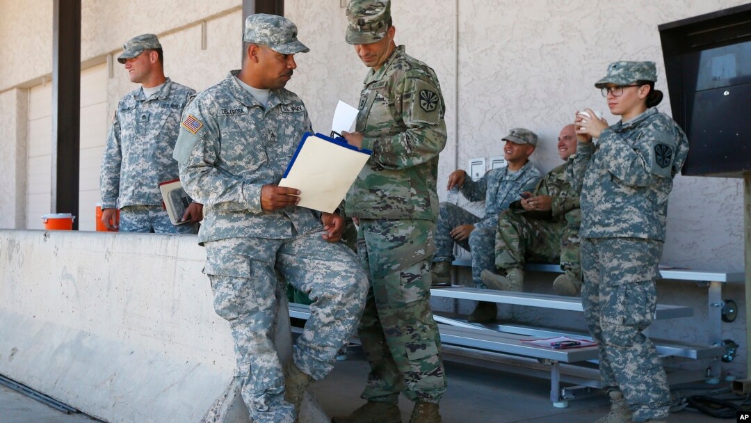 Arizona National Guard soldiers receive their reporting paperwork prior to deployment to the Mexico border at the Papago Park Military Reservation in Phoenix, April 9, 2018.