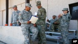 Arizona National Guard soldiers receive their reporting paperwork prior to deployment to the Mexico border at the Papago Park Military Reservation in Phoenix, April 9, 2018.