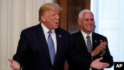 President Donald Trump and Vice President Mike Pence arrive at the Young Black Leadership Summit at the White House in Washington, Oct. 4, 2019. 