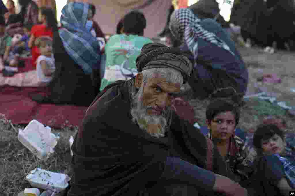 Internally displaced Afghans from northern provinces, who fled their home due to fighting between the Taliban and Afghan security personnel, take refuge in a public park in Kabul.