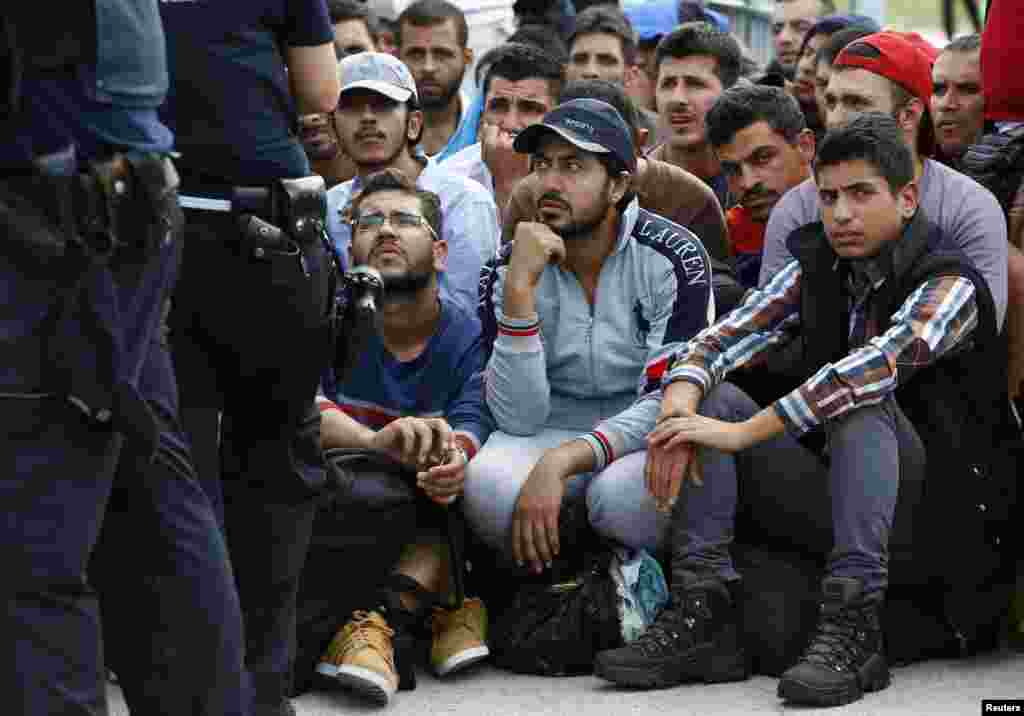 FILE - Migrants wait to cross the border from Austria near Freilassing, Germany, Sept. 17, 2015. The U.S. House of Representatives, which recently voted to suspend Syrian refugee resettlement, plans to take up a bill on visa waivers, an emerging risk.