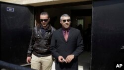 FILE - Al-Jazeera English journalists Canadian Mohamed Fahmy, right, and Egyptian Baher Mohammed leave a court after a hearing in their retrial near Tora prison in Cairo, Egypt, March 8, 2015. 