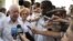 FILE - Former President Jimmy Carter (l) speaks with journalists, after visiting the Belen convent in Old Havana, Cuba, March 2011.