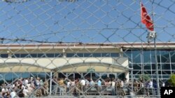 FILE - Turkish soldiers stand outside the court in a prison complex while people arrive, in Silivri, outside Istanbul, June 24, 2019.
