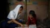 Yasmin, a Rohingya girl who was expelled from Leda High School for being a Rohingya, helps her younger sister to study in Leda camp in Teknaf, Bangladesh, March 5, 2019. REUTERS/Mohammad Ponir Hossain