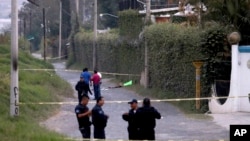 Policías del estado de Jalisco aseguran el área donde seis personas fueron encontradas con las manos cercenadas. 
