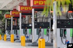 FILE - Closed gas pumps stand at a PDVSA gas station in Caracas, Venezuela, Sept. 8, 2020.