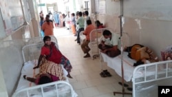 Patients and their bystanders are seen at the district government hospital in Eluru, Andhra Pradesh state, India, Dec.6, 2020, where over 200 people have been hospitalized due to an unidentified illness in this ancient city famous for hand woven products.