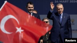 Turkey's President Erdogan and Murat Kurum greet their supporters during a rally in Istanbul