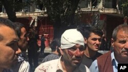 An injured man is seen after an explosion in Kabul, Afghanistan, May 31, 2017. A U.N. report released Monday, July 17, 2017, said Afghanistan's protracted war killed a record number of civilians during the first six months of this year.