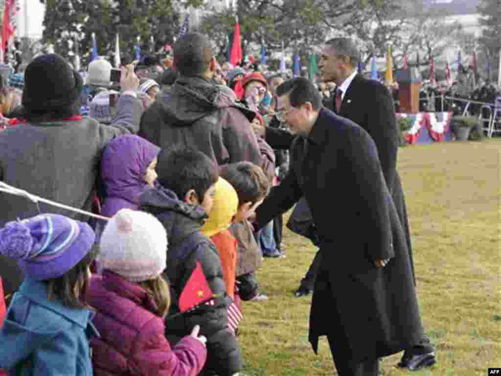 President Barack Obama and China's President Hu Jintao greet school children during a state arrival ceremony at the White House in Washington, Wednesday, Jan. 19, 2011. (AP Photo/J. Scott Applewhite)