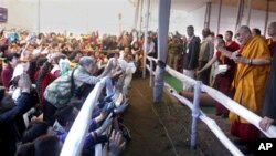 Tibetan spiritual leader the Dalai Lama, right, meets Chinese devotees during the Kalachakra Buddhist festival in the town of Bodh Gaya, believed to be the place where Buddha attained enlightenment, in the eastern Indian state of Bihar, Tuesday, Jan. 3, 2