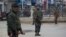 Indian paramilitary soldiers stand guard in a closed market in Srinagar, Indian-controlled Kashmir, Feb. 23, 2019.