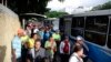 People stand in a bus line in Caracas, Venezuela, July 23, 2019. 
