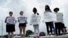 Supporters gather on the street as Democrats from the Texas Legislature arrive by bus to board a private plane headed for Washington, D.C., July 12, 2021, in Austin, Texas.