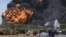 A fire burned for a third day in two fuel storage tanks at Venezuela's biggest refinery, August 27, 2012.
