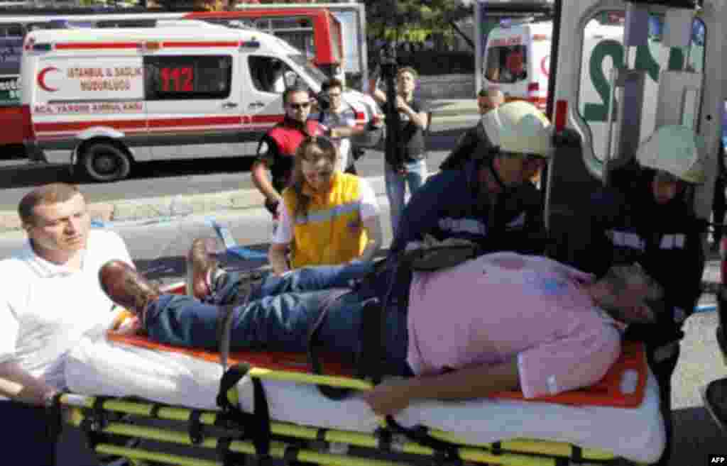 A wounded man is taken to an ambulance following a blast in Istanbul May 26, 2011. A bomb placed on an electric bicycle exploded in Istanbul on Thursday, wounding seven people, Istanbul's police chief Huseyin Capkin told reporters. He said none of the wou