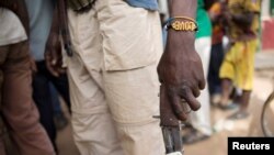 FILE - A member of the of an Anti-Balaka armed militia displays his weapon in the town of of Bocaranga, Central African Republic, April 28, 2017.
